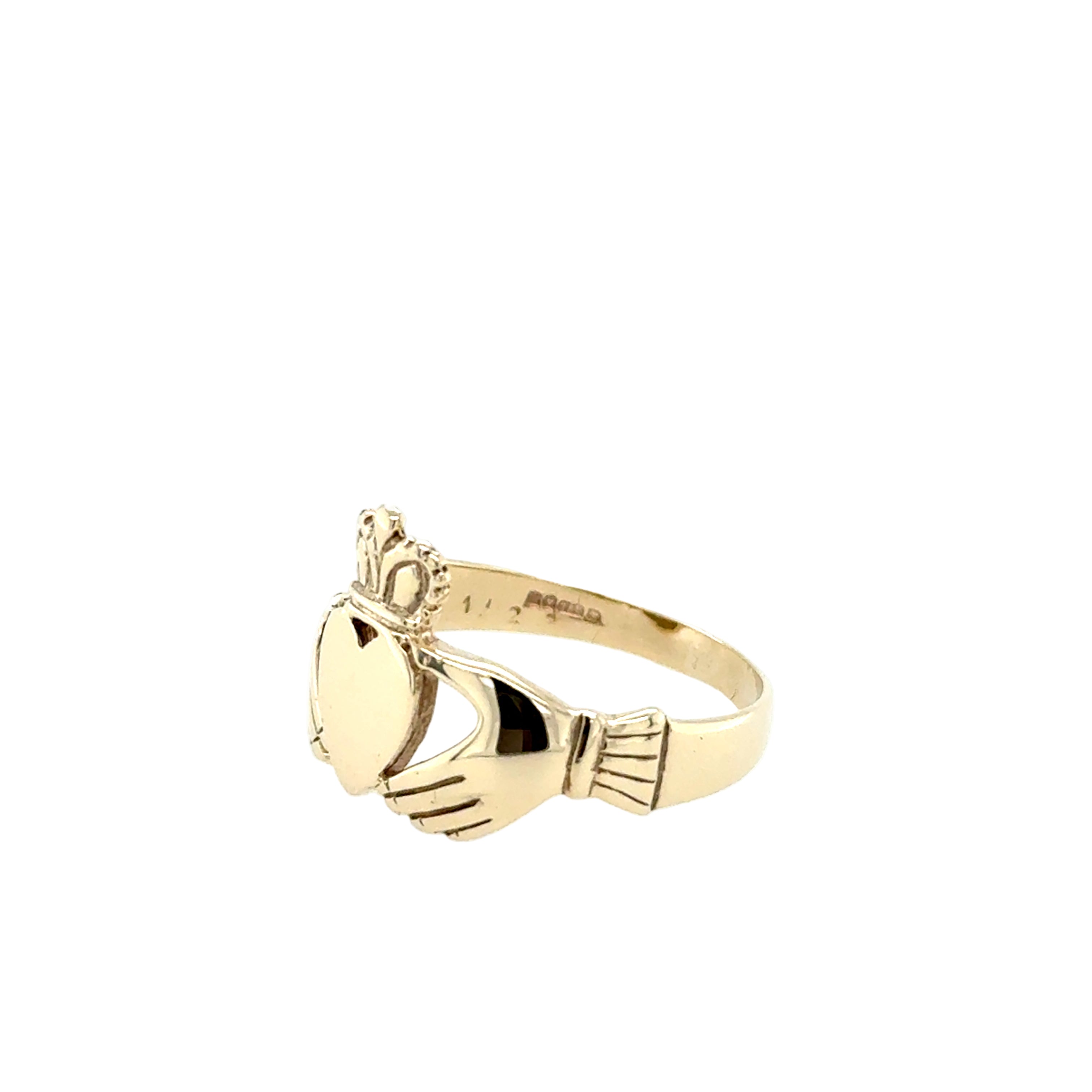 Gold ring with claddagh design on a white background