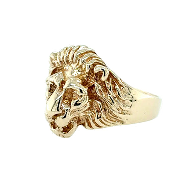 Gold lion head ring on a white background