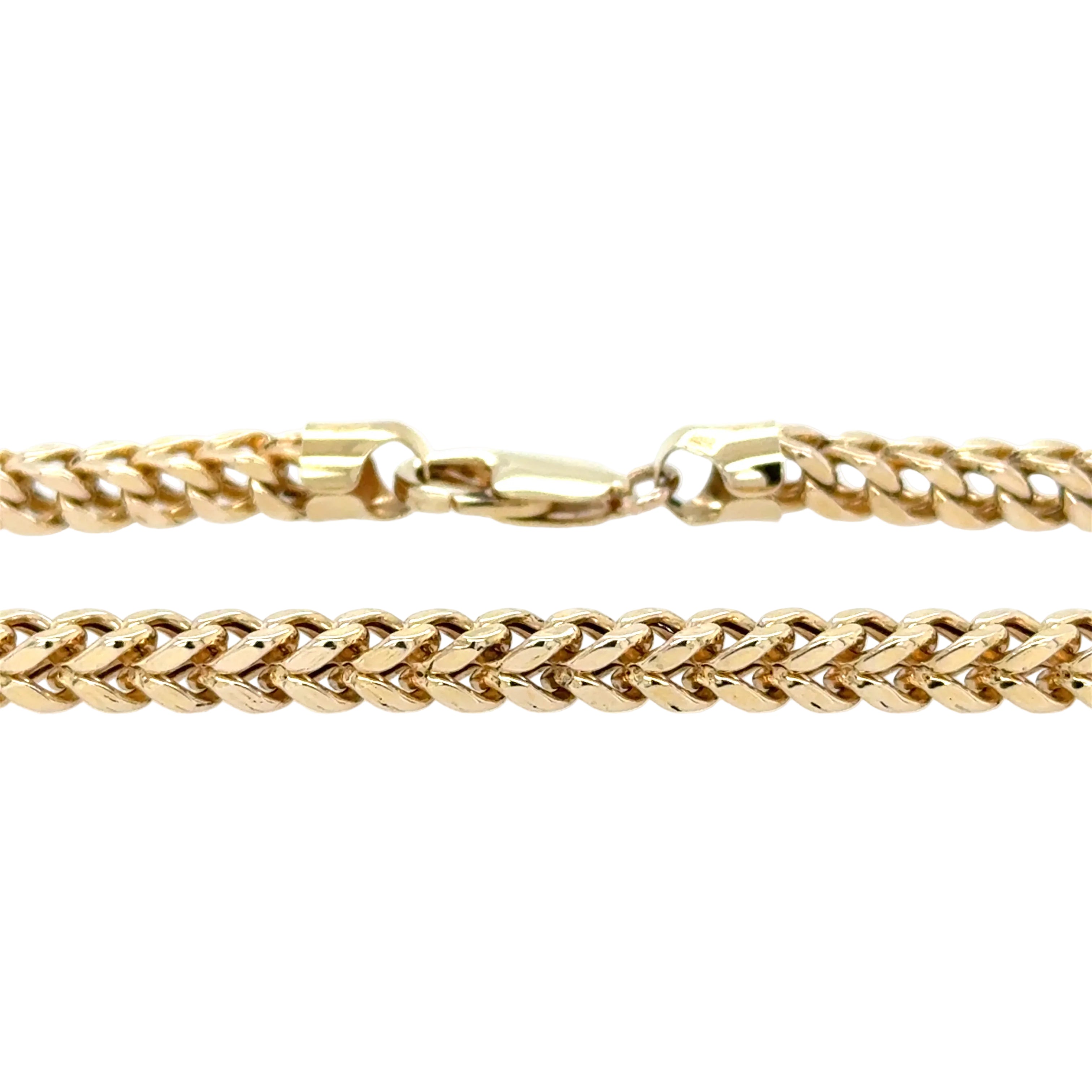 Gold chain bracelet on a white background