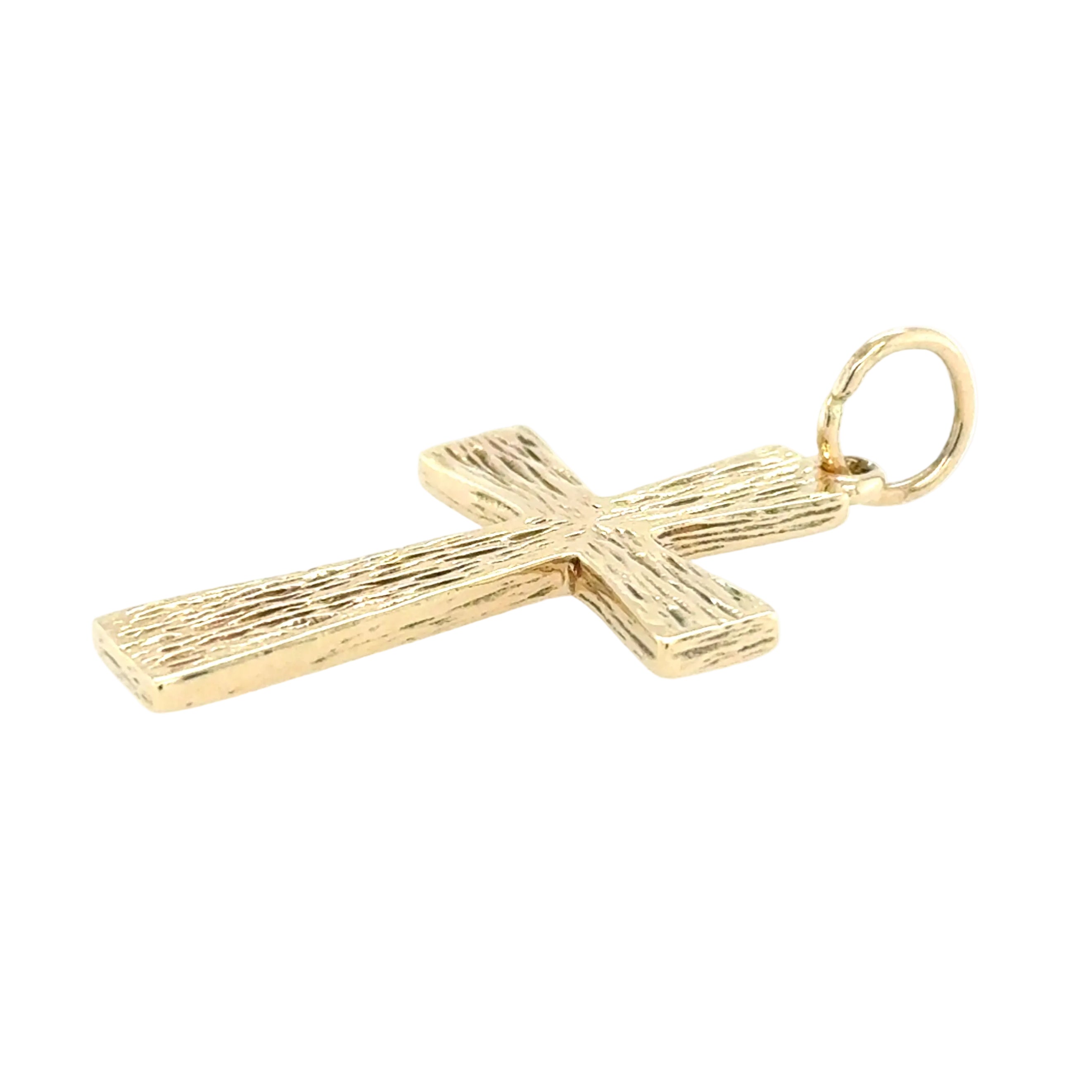 Gold cross pendant on a white background